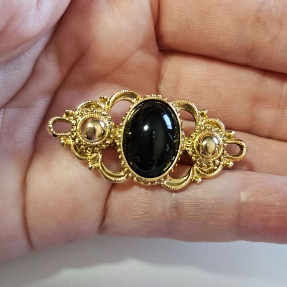 1928 brand gold tone with black brooch